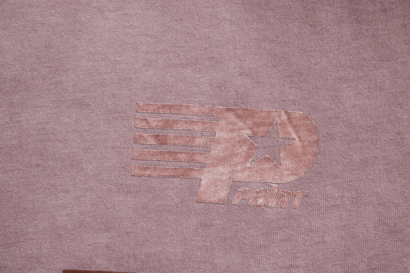 Vintage wash mauve tee with faded retro racing print and star logo on soft cotton fabric