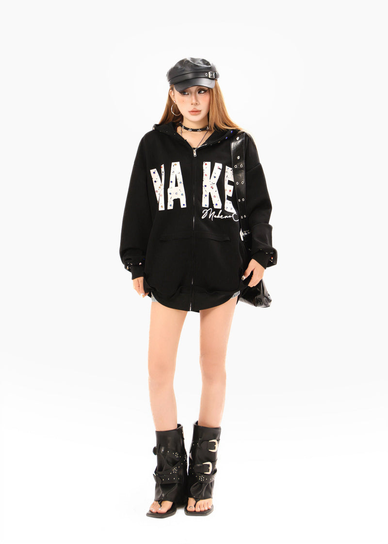 Black oversized zip hoodie worn by model, full-length front view with studded details