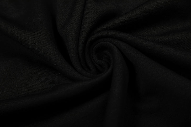 Close-up of black fabric texture with soft folds