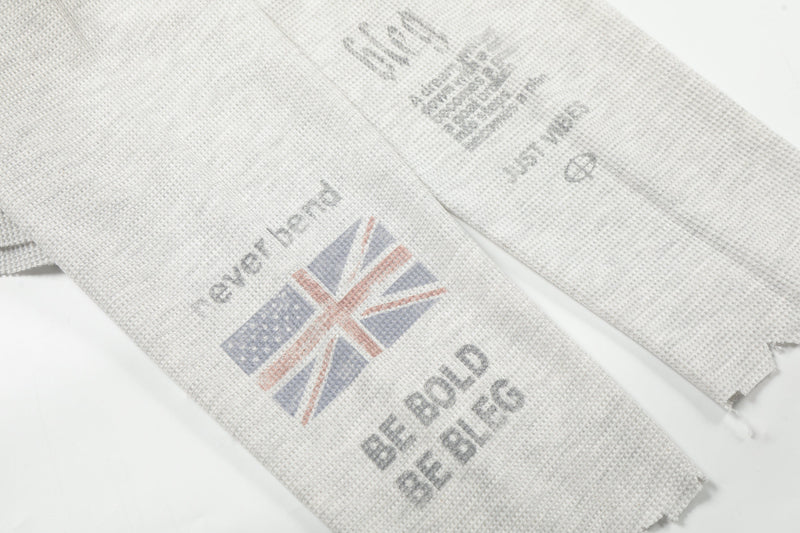Flat lay of light gray long sleeve tee front and back views with Union Jack graphics