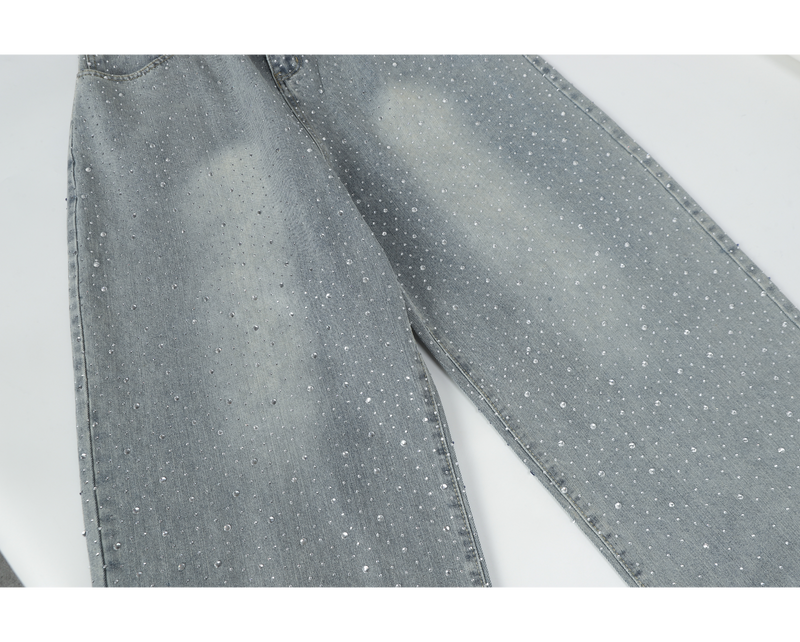 Side view of light-wash wide-leg jeans with rhinestones along the legs