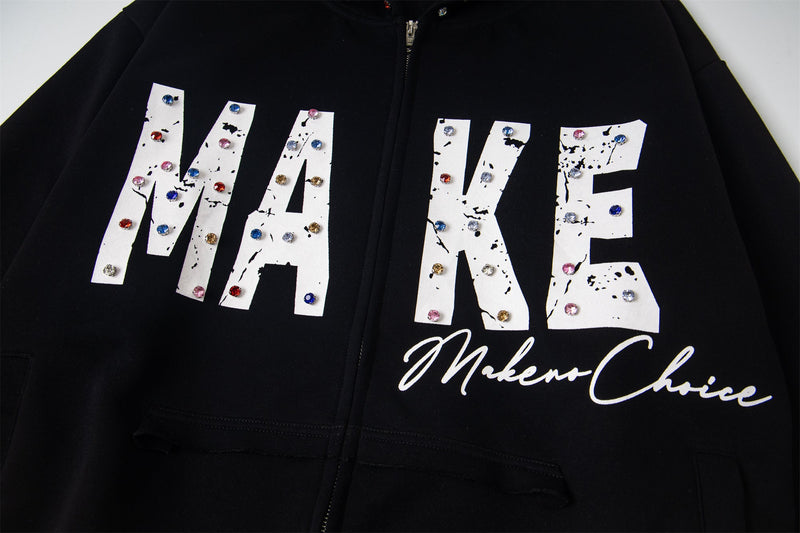 Close-up of black hoodie chest graphic with MAKE lettering and script text