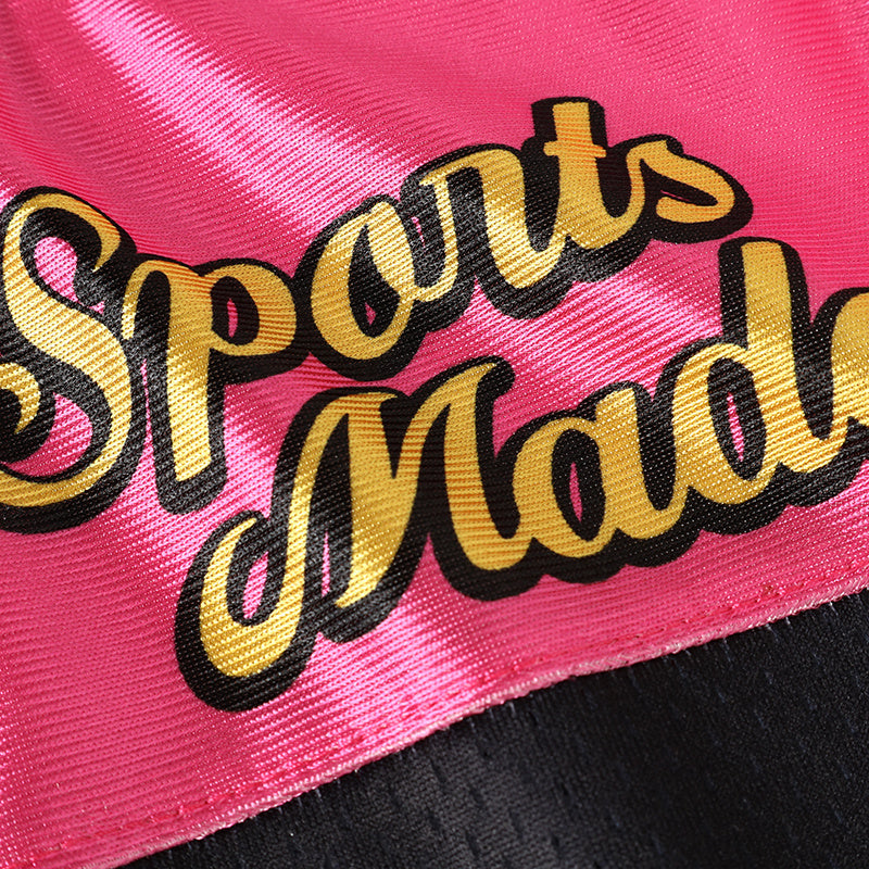 Pink satin football jersey detail with gold and black Sports Mode lettering on a black trim edge
