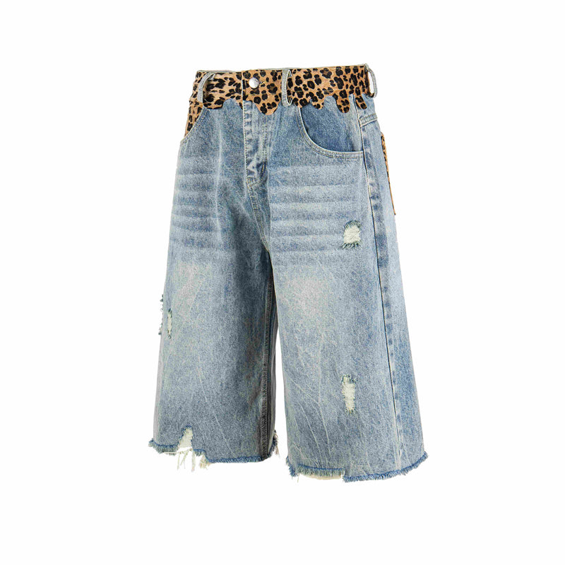 Angled front view of light wash denim shorts with leopard waistband, ripped details, and wide legs