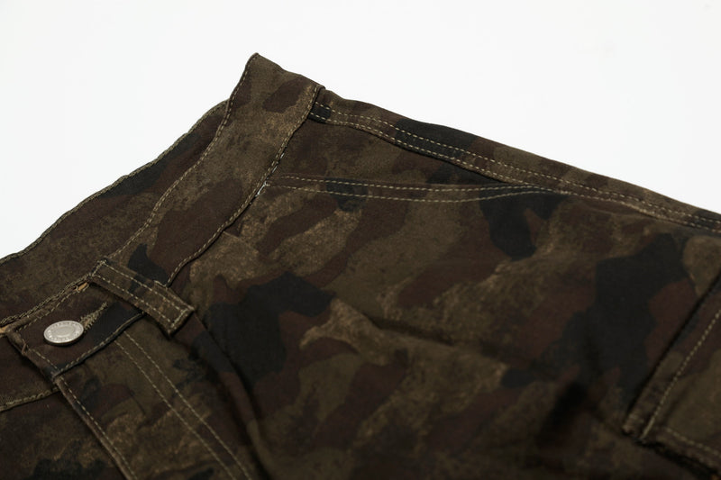 Close-up of camo shorts waistband with button closure and top stitching