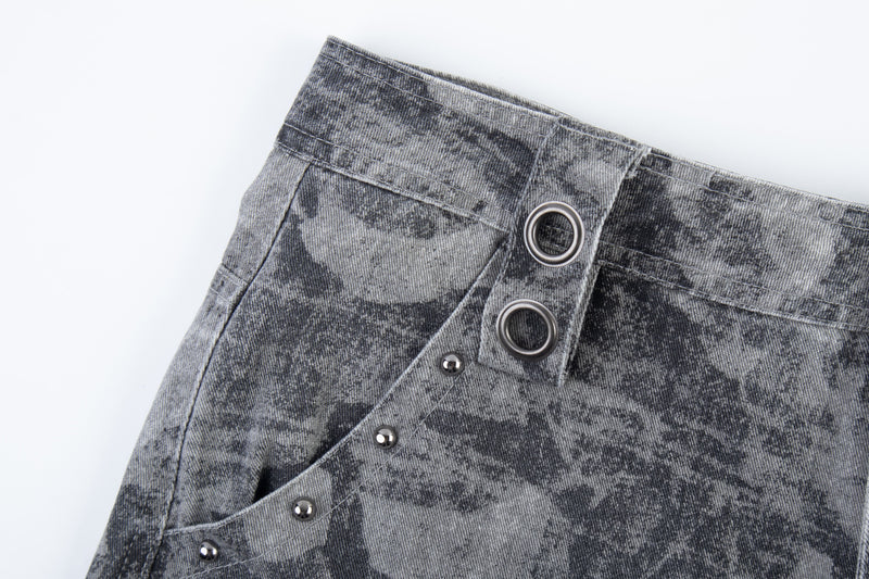 Close-up of gray distressed camo pants waistband and snap details