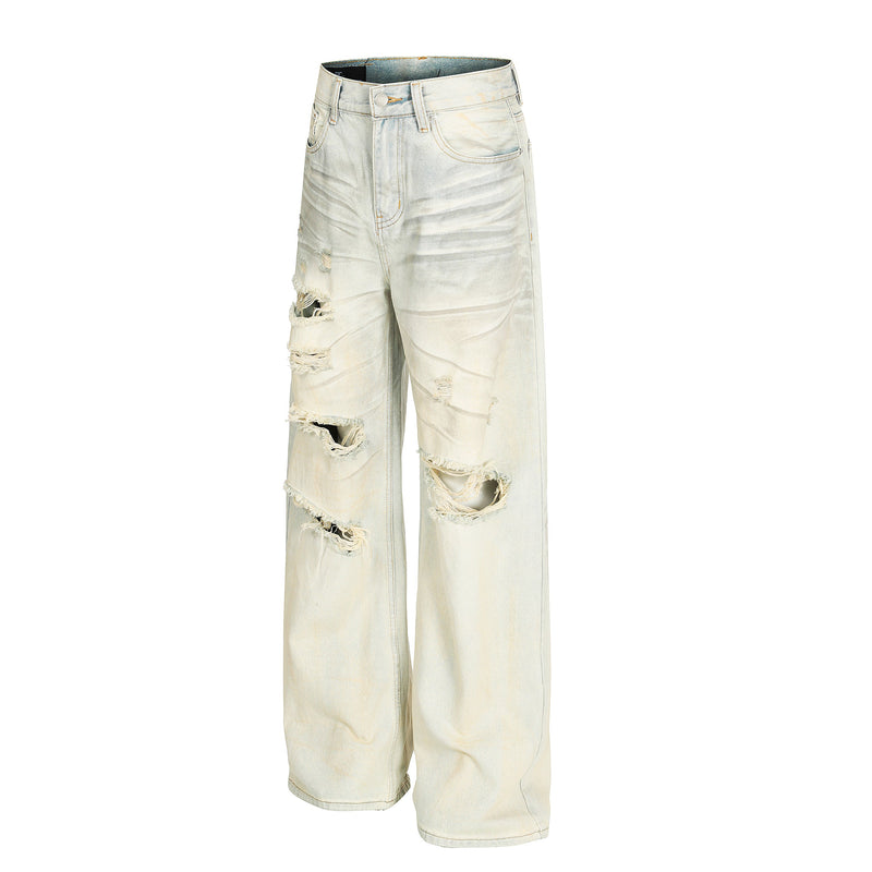 Cream distressed wide-leg jeans with ripped front and wide hems, angled view
