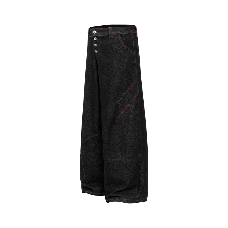 Side view of black wide leg denim pants with contrast red stitching and button fly