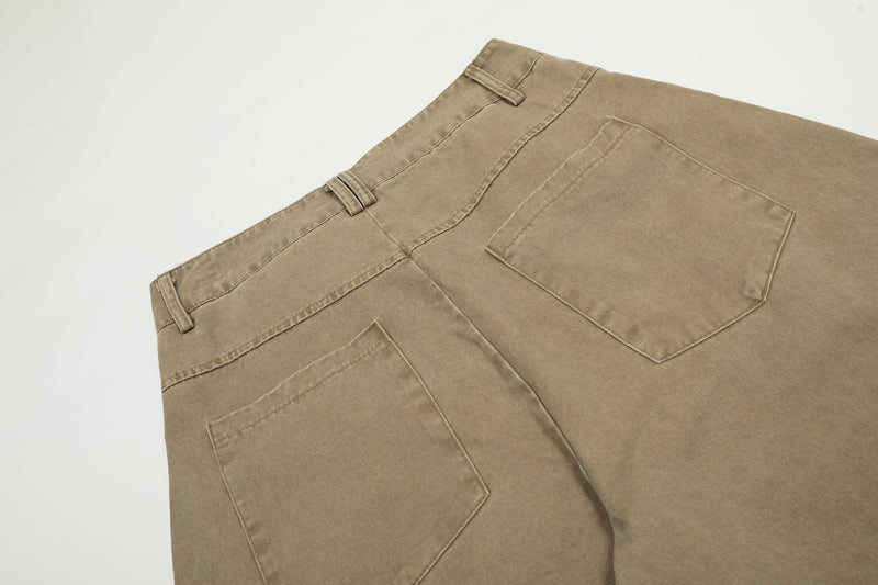 Back view detail of the waistband and patch pockets on khaki pants