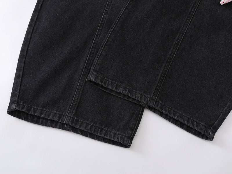 Close-up of black jeans hem and stitched side seam