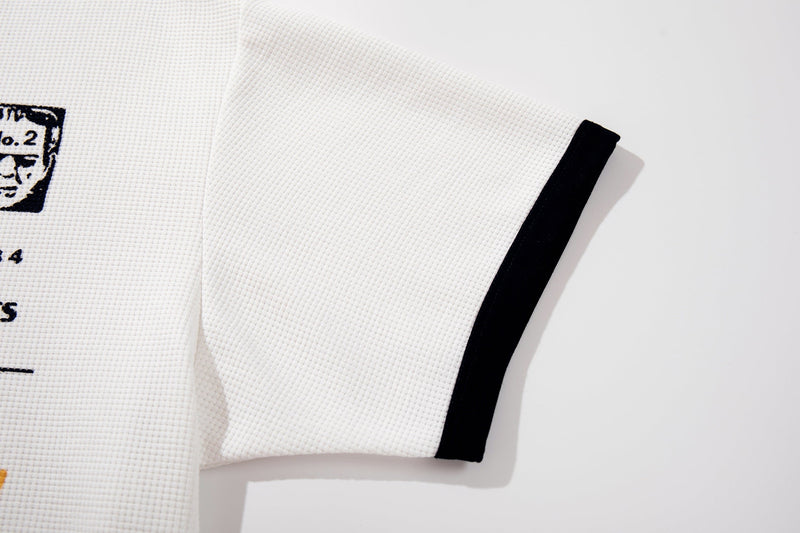 White textured ringer T-shirt with black sleeve cuff and partial vintage graphic print on the chest