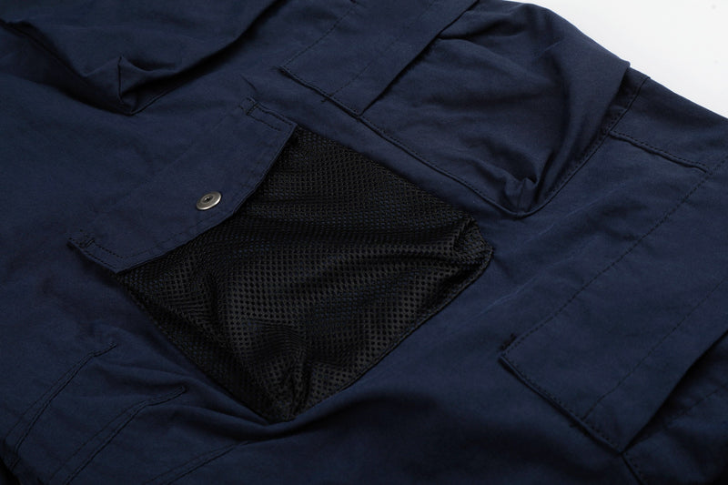 Close-up of navy cargo pants mesh cargo pocket and flap detail
