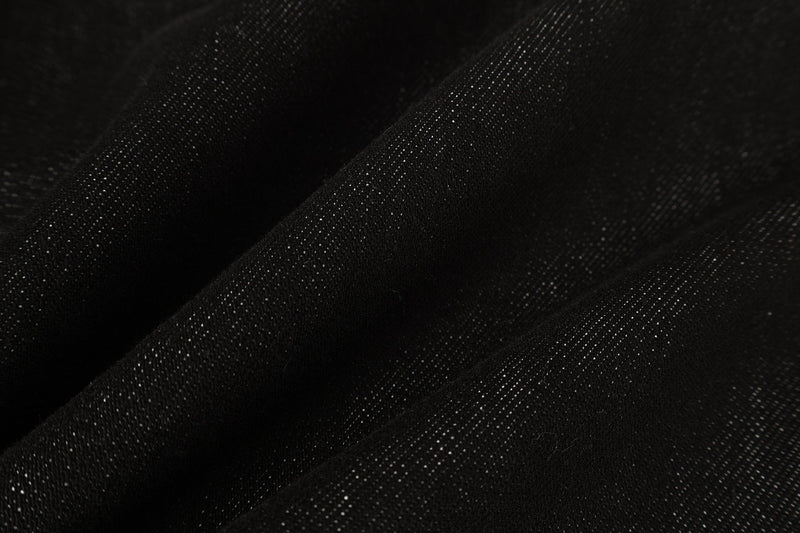Close-up of black denim fabric texture with fine diagonal weave