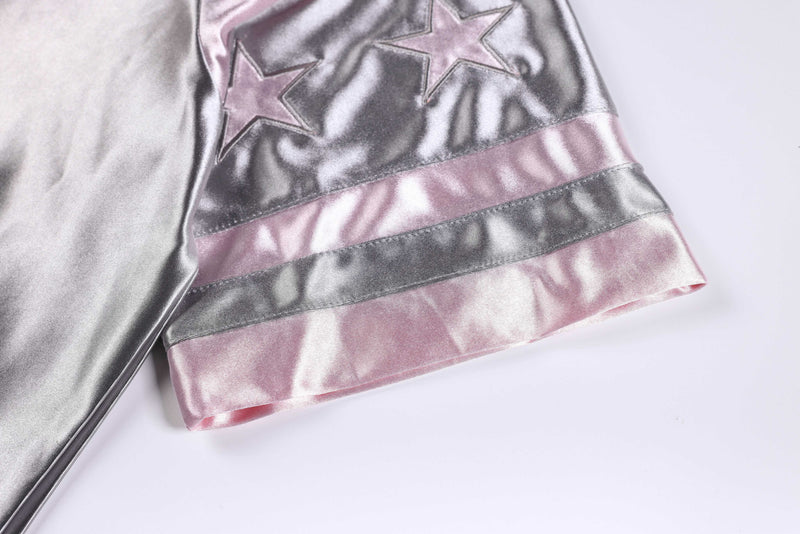 Metallic pink and silver oversized varsity jersey tee with star accents and striped hem on white background