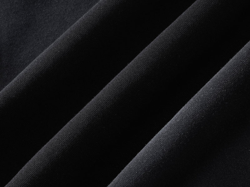 Close-up of black hoodie fabric showing smooth knit texture and drape