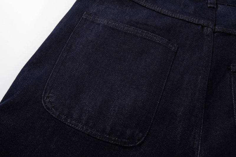 Close-up of dark wash jeans back pocket with curved stitching