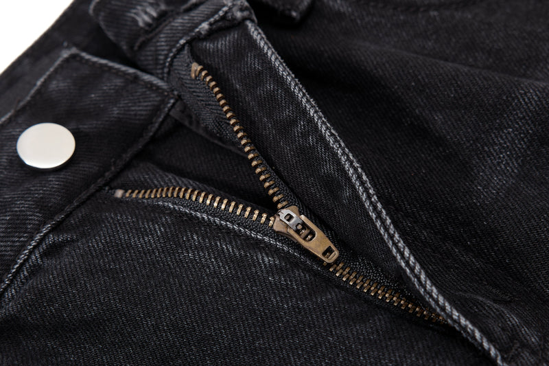Close-up of jeans fly with metal zipper and silver button