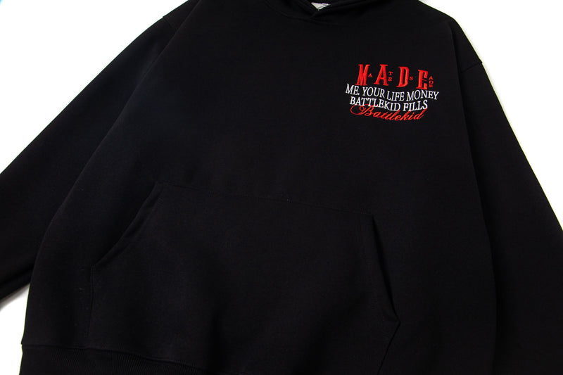 Black hoodie front close-up of chest embroidery and kangaroo pocket