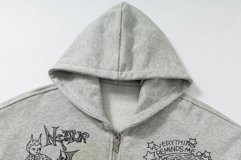 Close-up of grey hoodie hood and upper front with black doodle print
