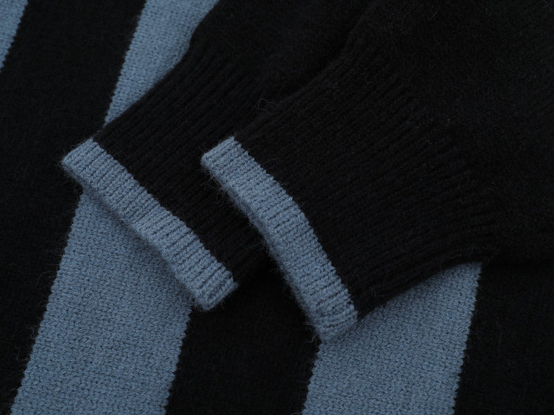 Close-up of black and blue knit stripes with textured ribbed fabric detail