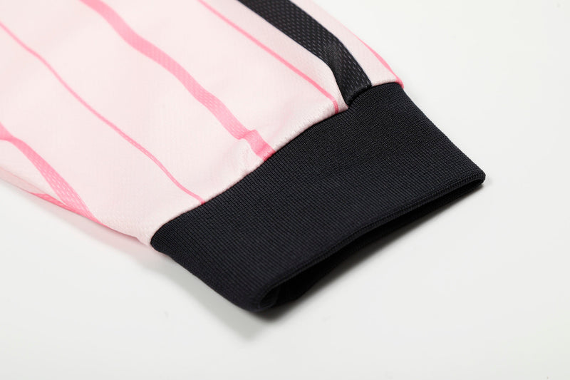 Close-up of pink jersey cuff with black ribbed sleeve trim