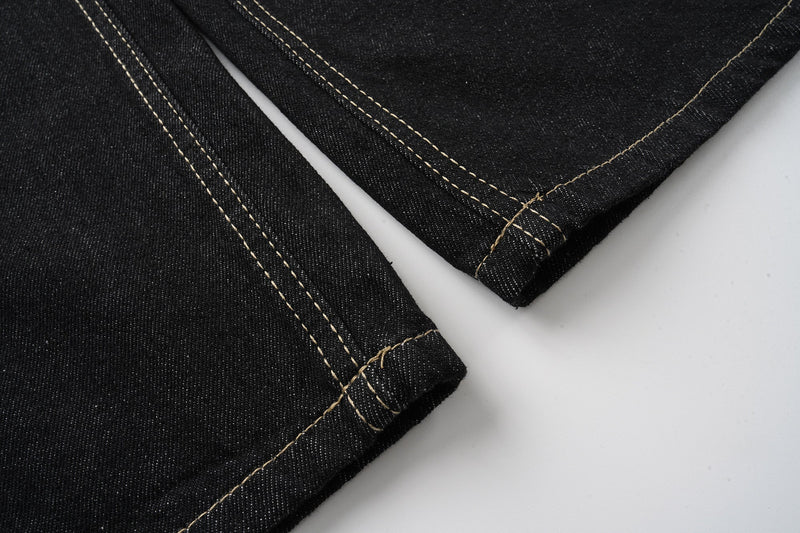 Black jeans hem close-up with contrast topstitching