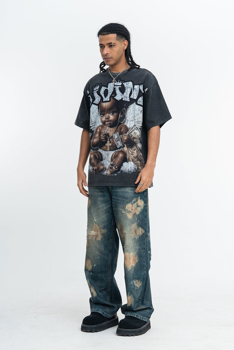 Black vintage wash graphic T-shirt with baby angel print, worn with distressed baggy jeans and black shoes
