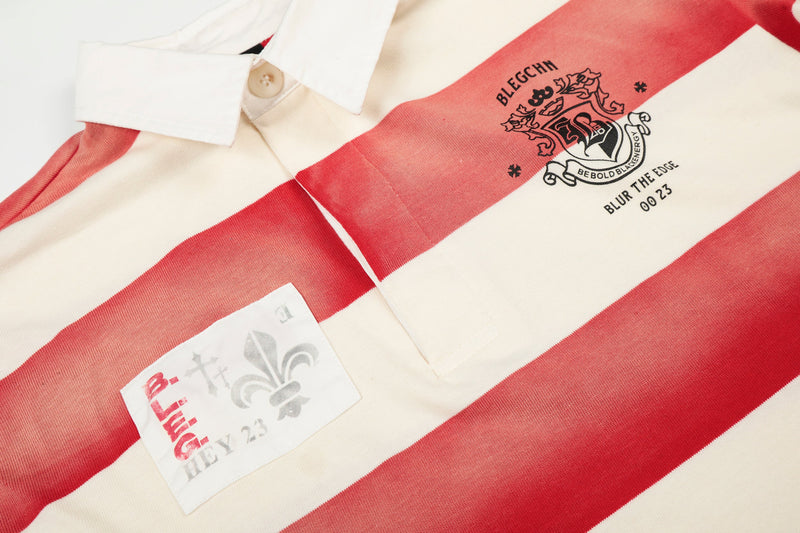 Close-up of front chest graphics on cream and red striped rugby polo shirt