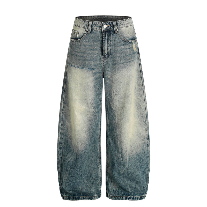Front view of wide-leg faded blue jeans with whiskering, five pockets, and light distressing