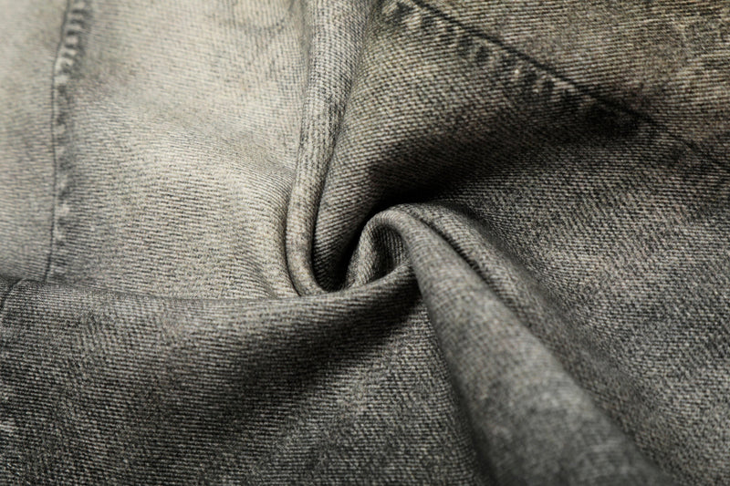 Close-up of denim fabric texture with soft folded drape