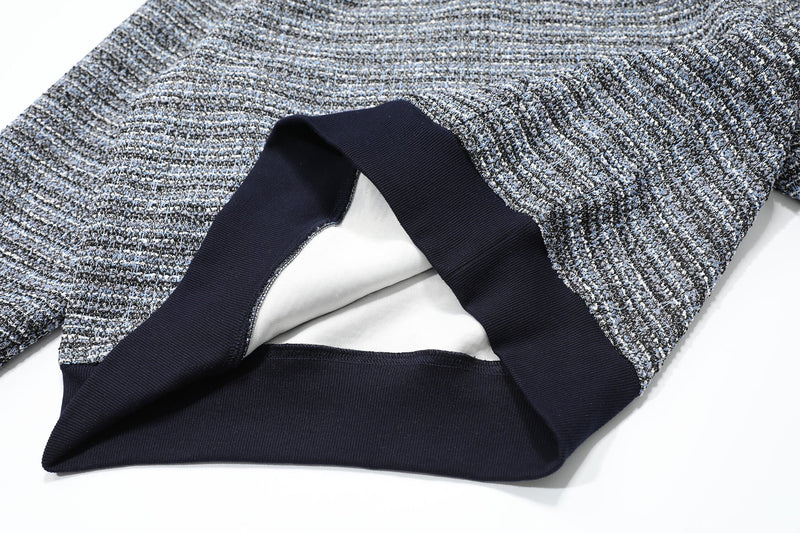 Close-up of the hoodie front opening with dark ribbed trim and inner lining