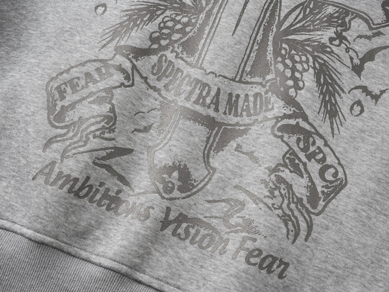 Close-up of gray hoodie back print with cross crest, bats, and text