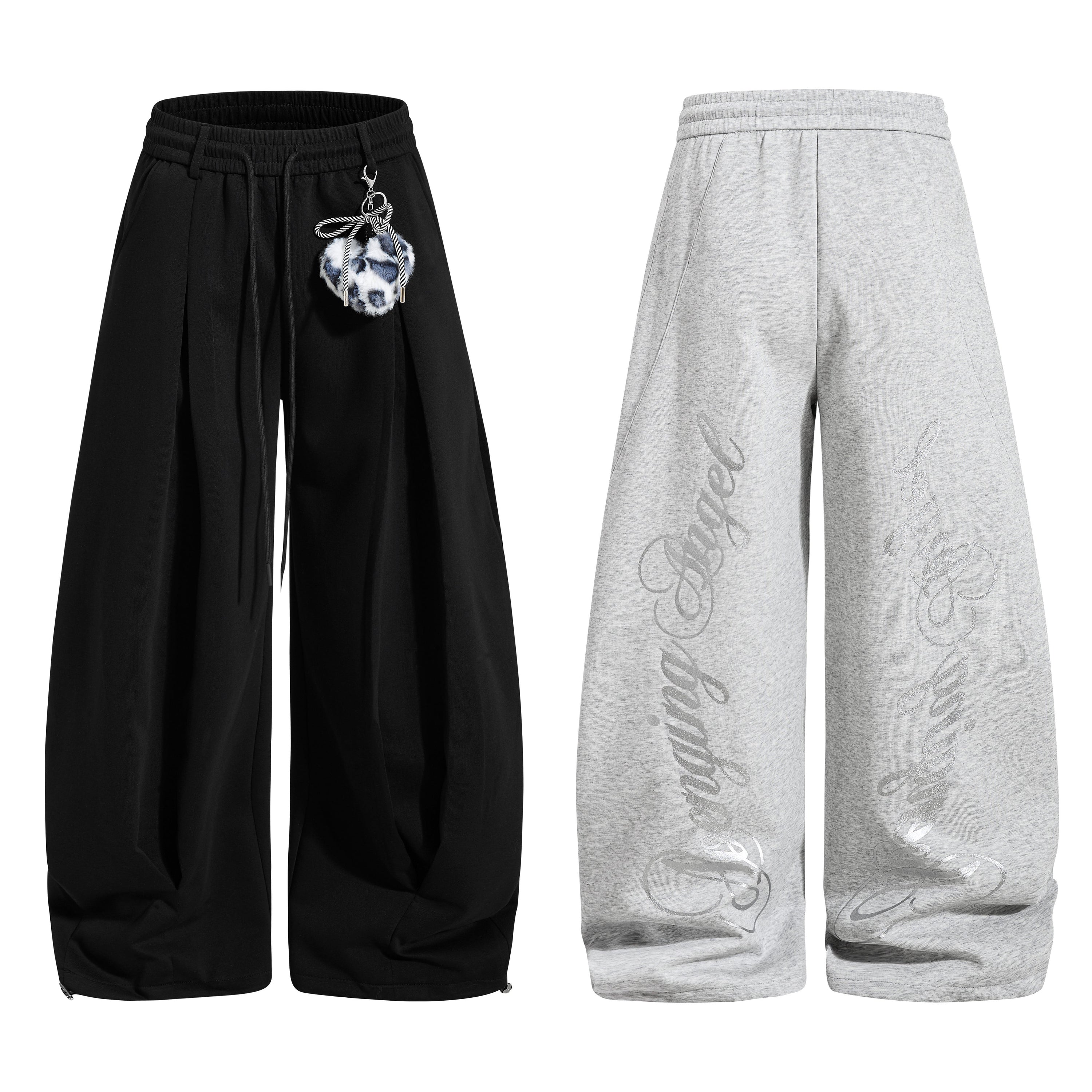 Black wide-leg sweatpants with pleated front, adjustable drawstring and leopard pom-pom charm, product flat lay