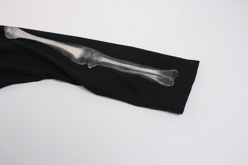 Close-up of black sleeve with white forearm bone print on waffle-knit tee