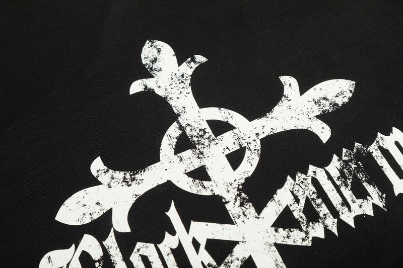 Close-up of white gothic cross graphic printed on black tee