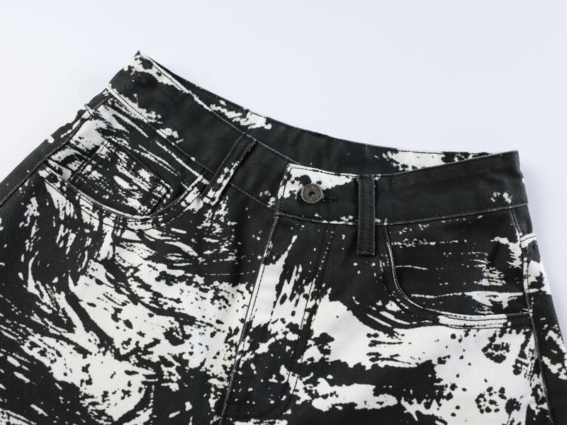 Close-up of front waistband on black and white animal print jeans with button closure