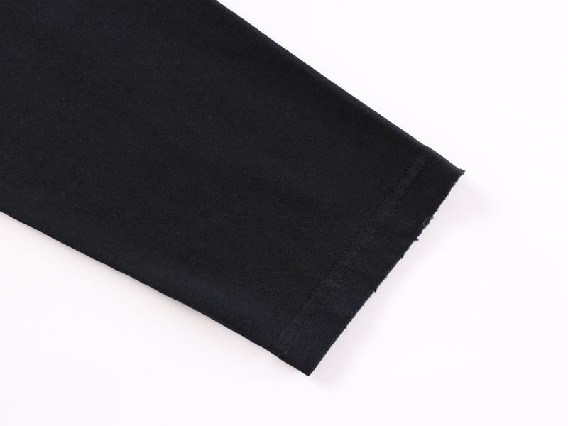 Close-up of black sleeve cuff with double stitching