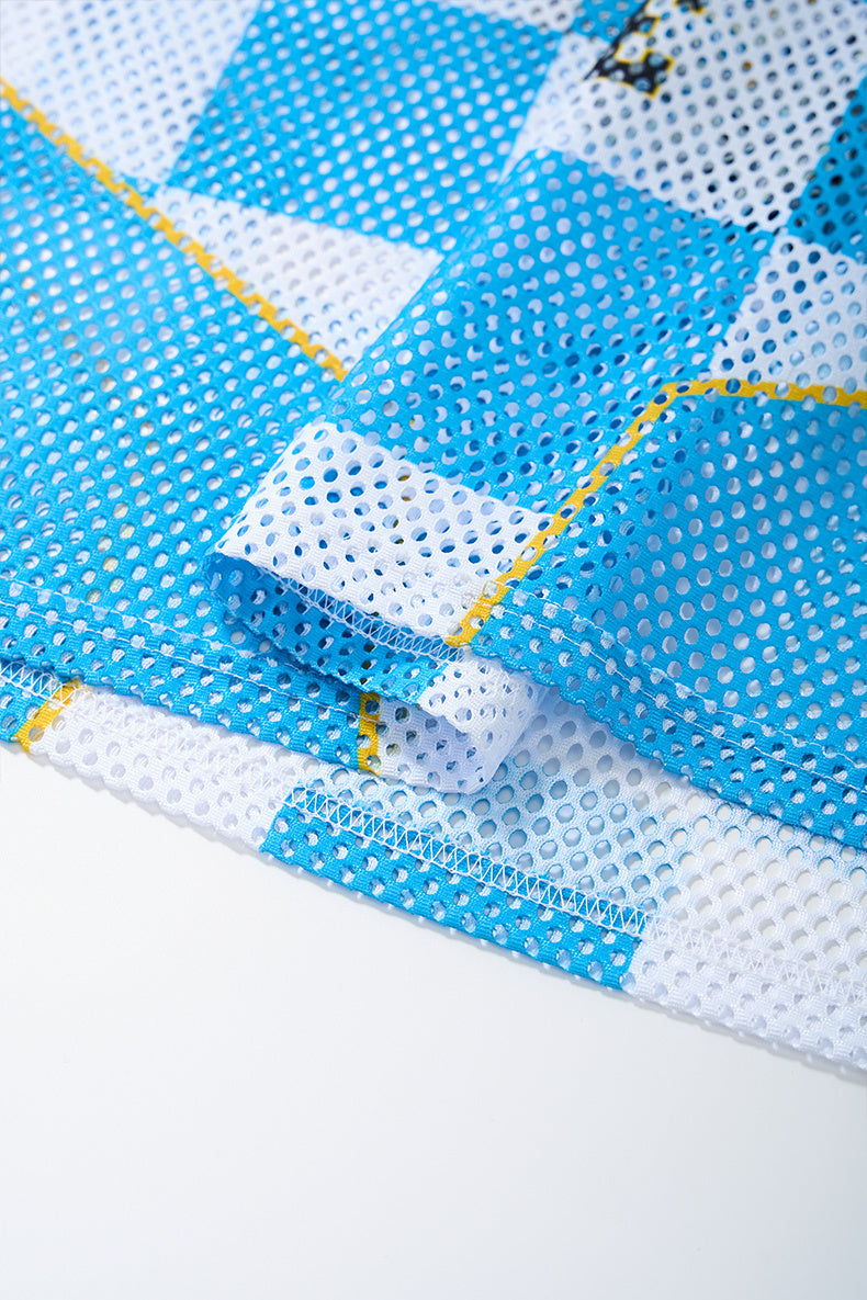 Blue and white checkerboard mesh jersey fabric with yellow trim and visible stitched hem detail