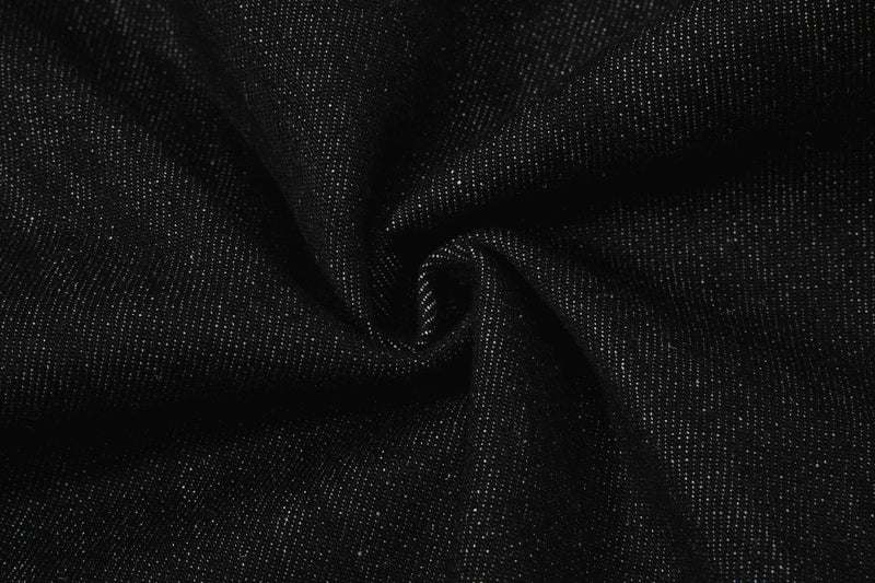 Close-up of black denim fabric draped in folds