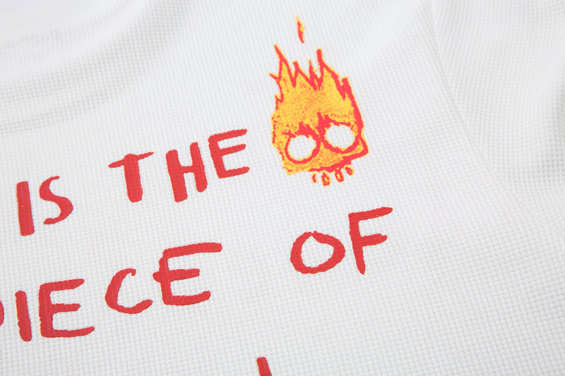 Close-up of back print showing is the piece of and flame doodle on white fabric