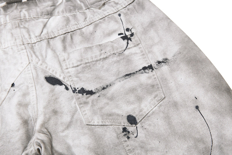 Close-up of back pocket and splatter detail on gray denim