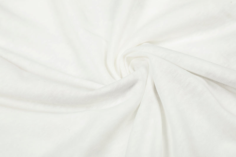 Close-up of white tee fabric gathered in a swirl