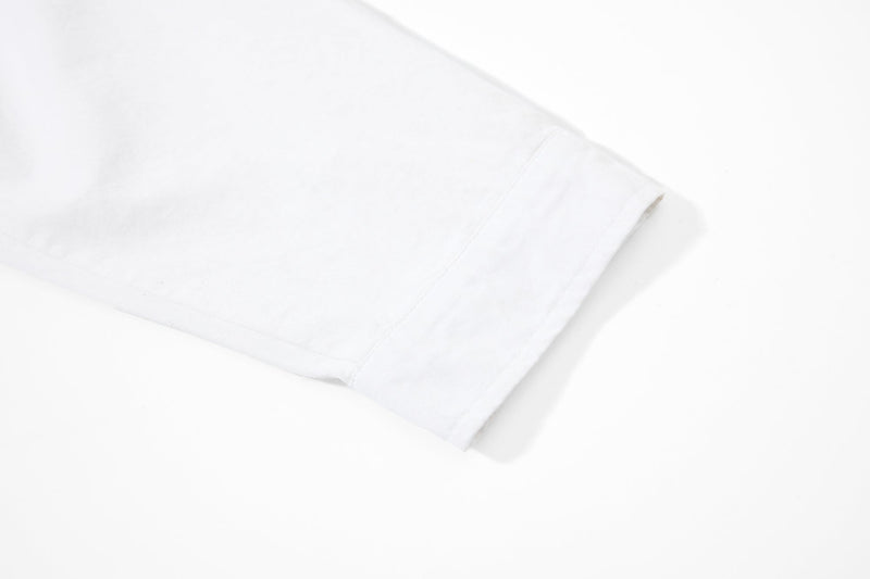 Close-up of plain white sleeve cuff on long-sleeve rugby polo