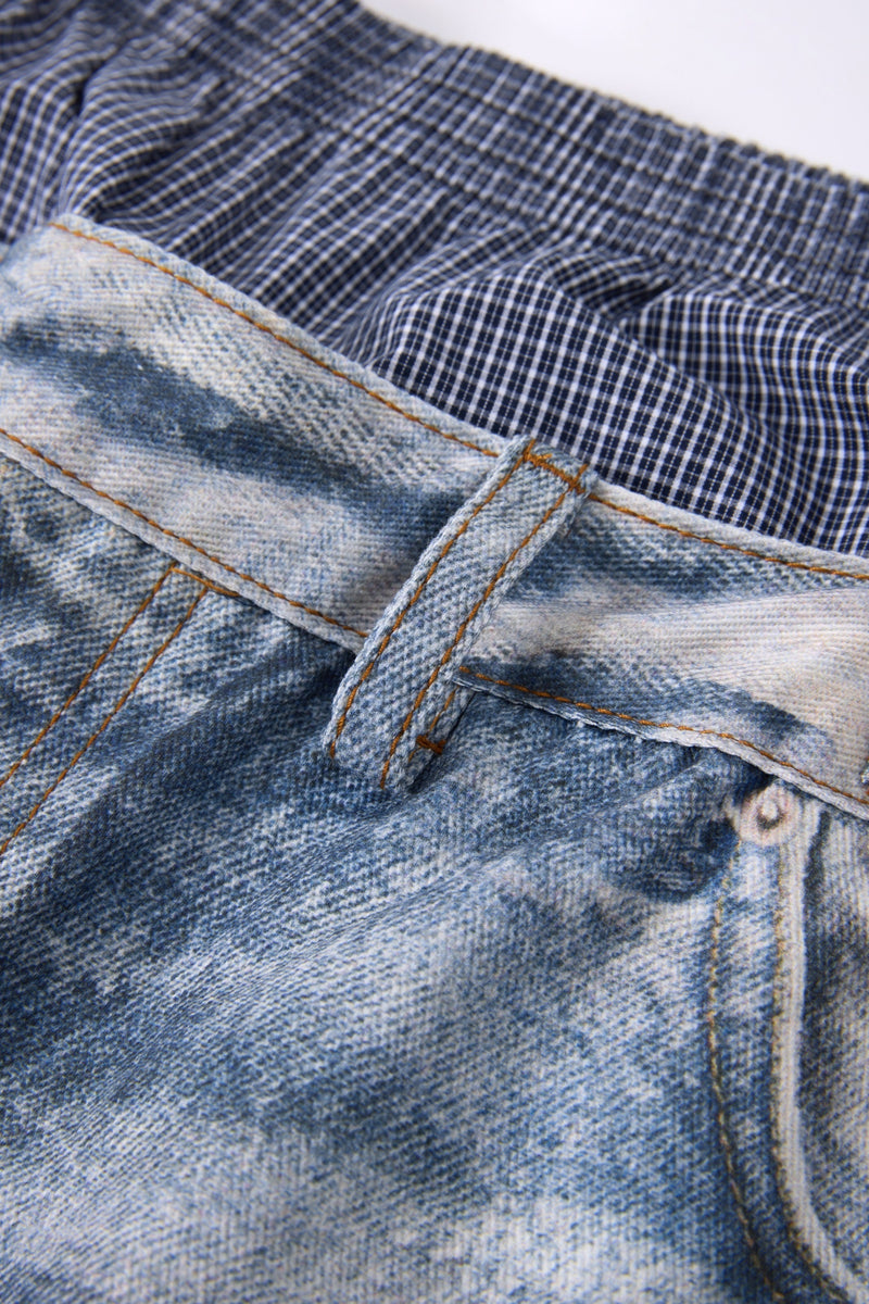 Close-up of front waistband seam on plaid layered-waist distressed jeans