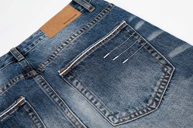 Close-up of back pocket and waistband label on blue faded denim jeans