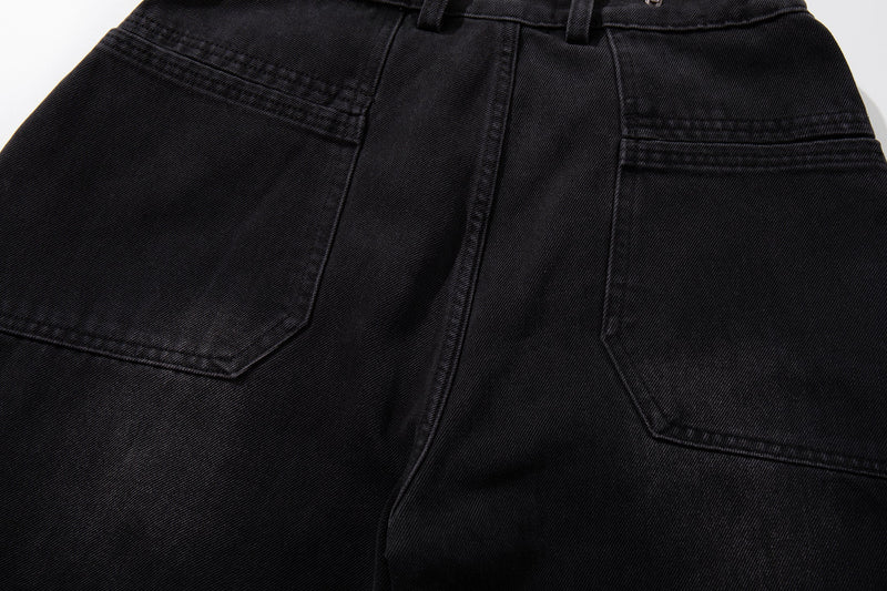 Close-up of back pockets and seam detail on dark denim wide-leg jeans