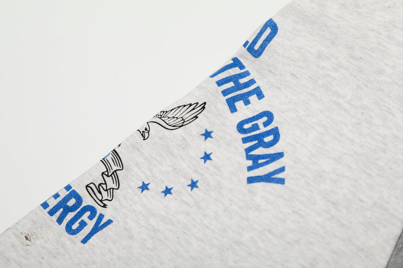 Close-up of white sleeve with blue lettering, stars, and eagle graphic print