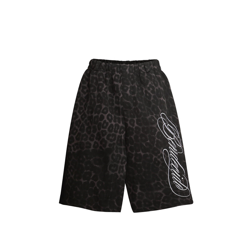 Front view of black leopard print loose shorts with white script graphic on the leg