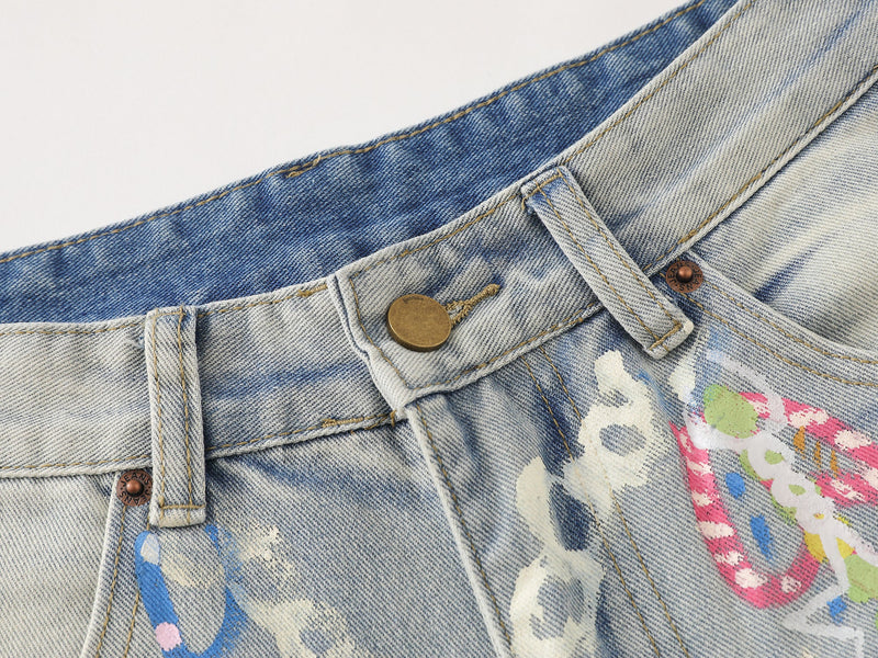 Close-up of waistband on light wash denim pants with button and belt loop detail