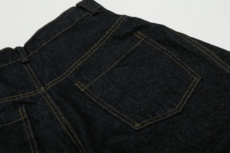 Close-up of back pocket and seam stitching on black denim pants